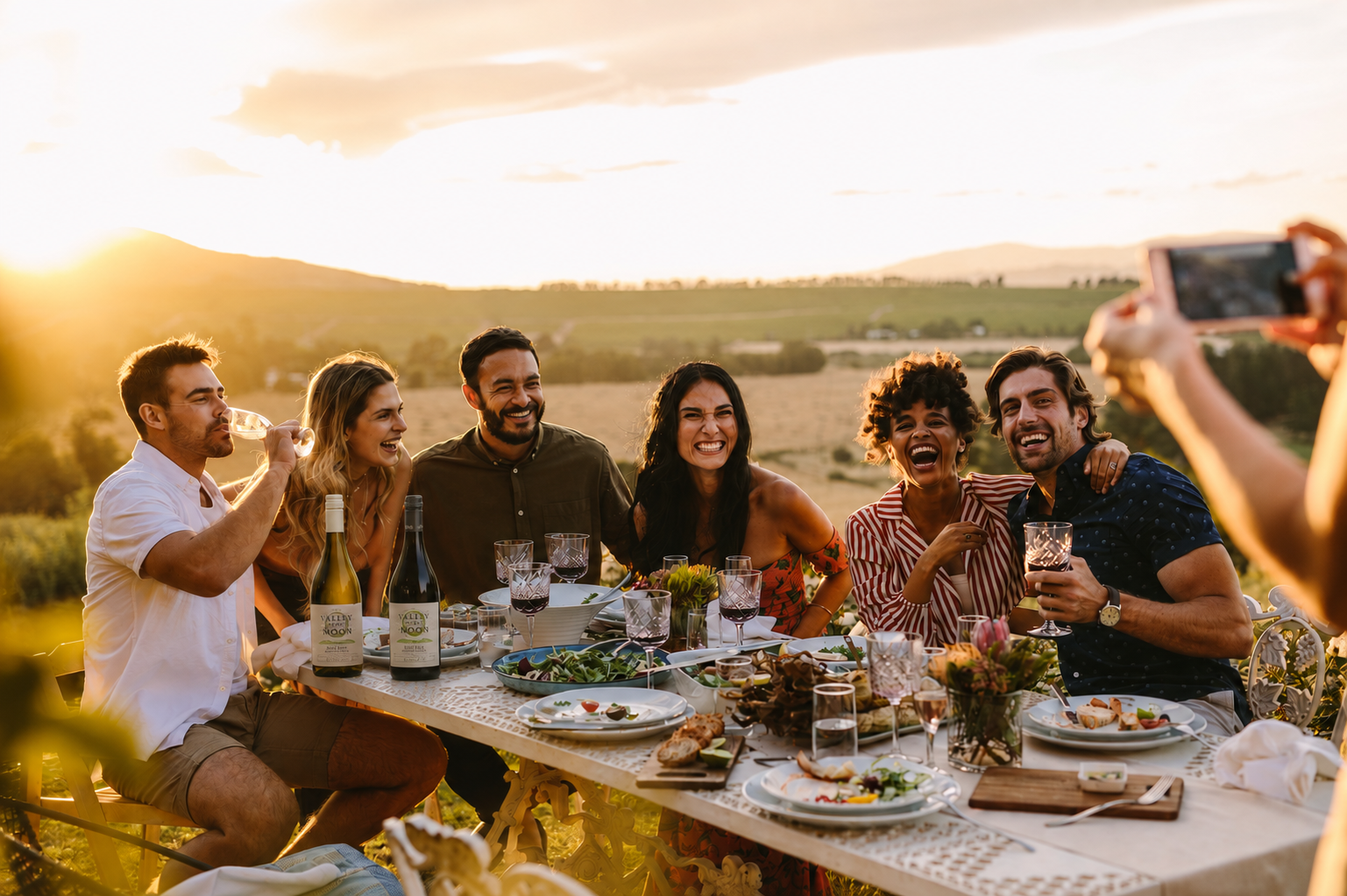 People enjoying Valley of the Moon wines at an outdoor dinner setting and taking a selfie